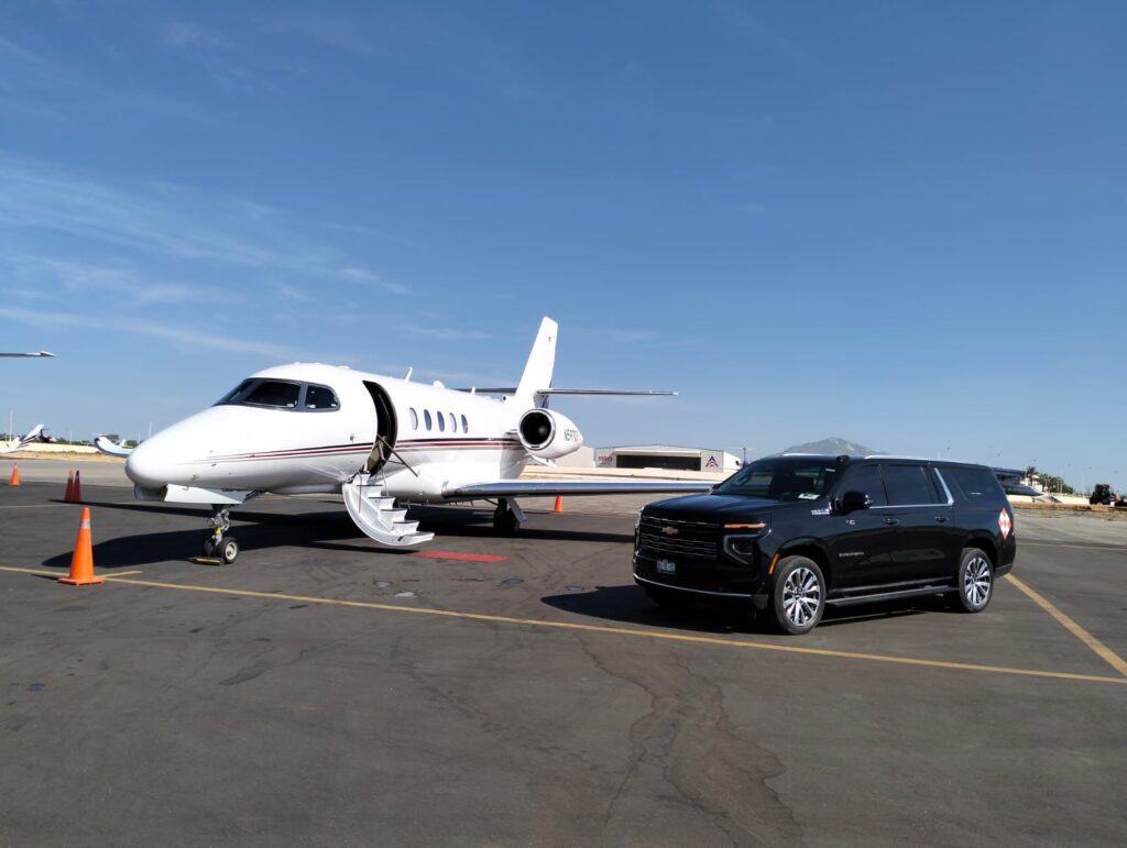 Luxury SUV waiting beside a private jet on the tarmac