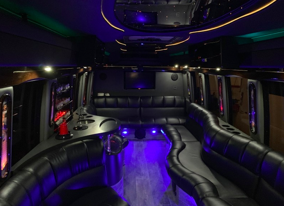 Party bus interior with leather lounge seating and ambient lighting